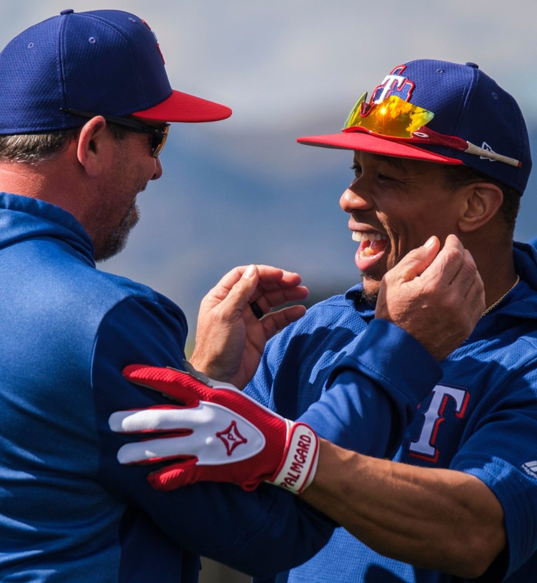 Texas Rangers outfielder Ben Revere (right) hugs a member of the coaching staff during the...