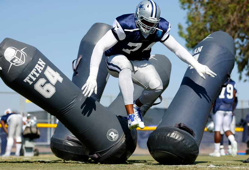 Dallas Cowboys defensive end Lawrence Okoye (74) battles through the blocking dummies during...