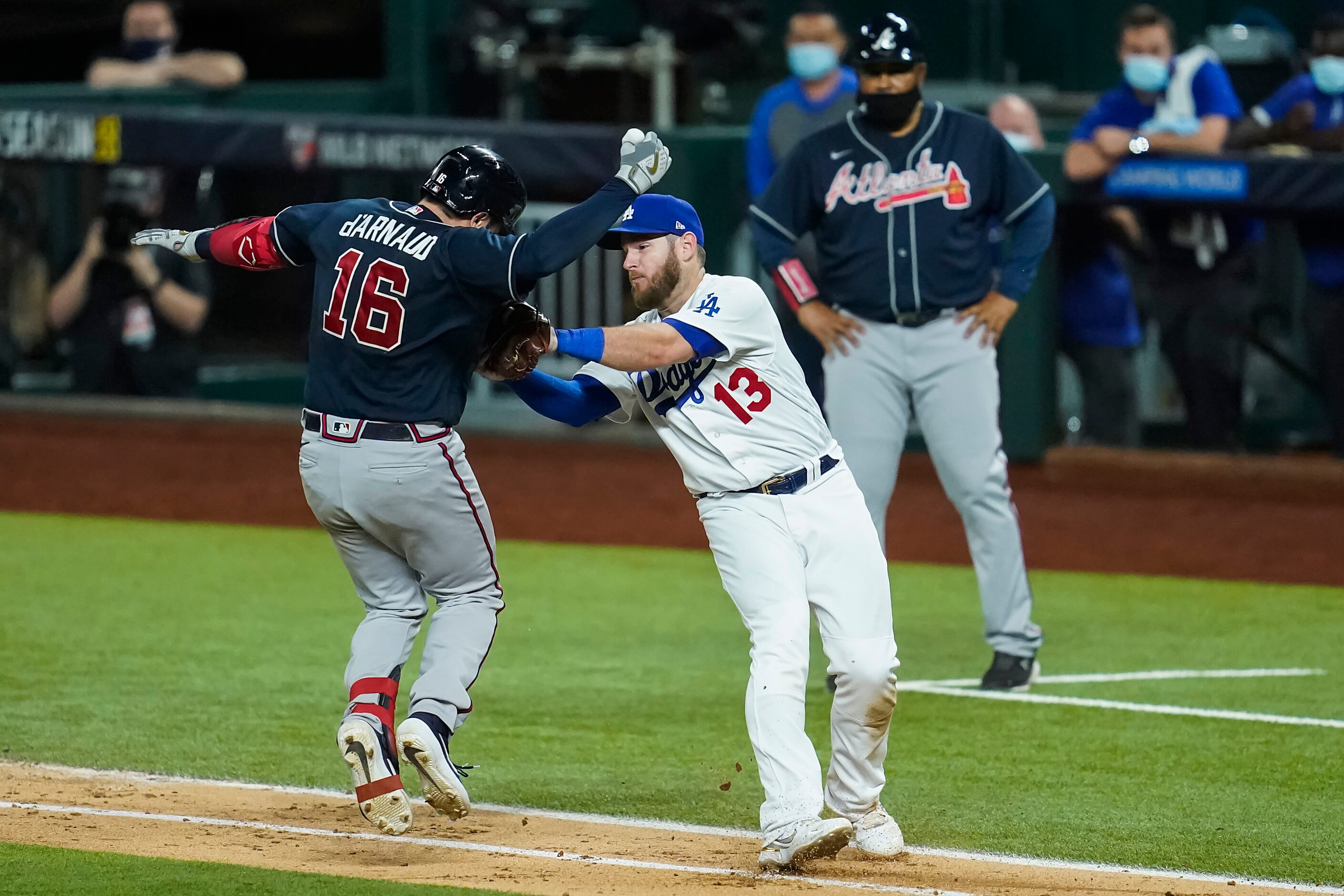 Los Angeles Dodgers first baseman Max Muncy (13) puts the tag on Atlanta Braves catcher...