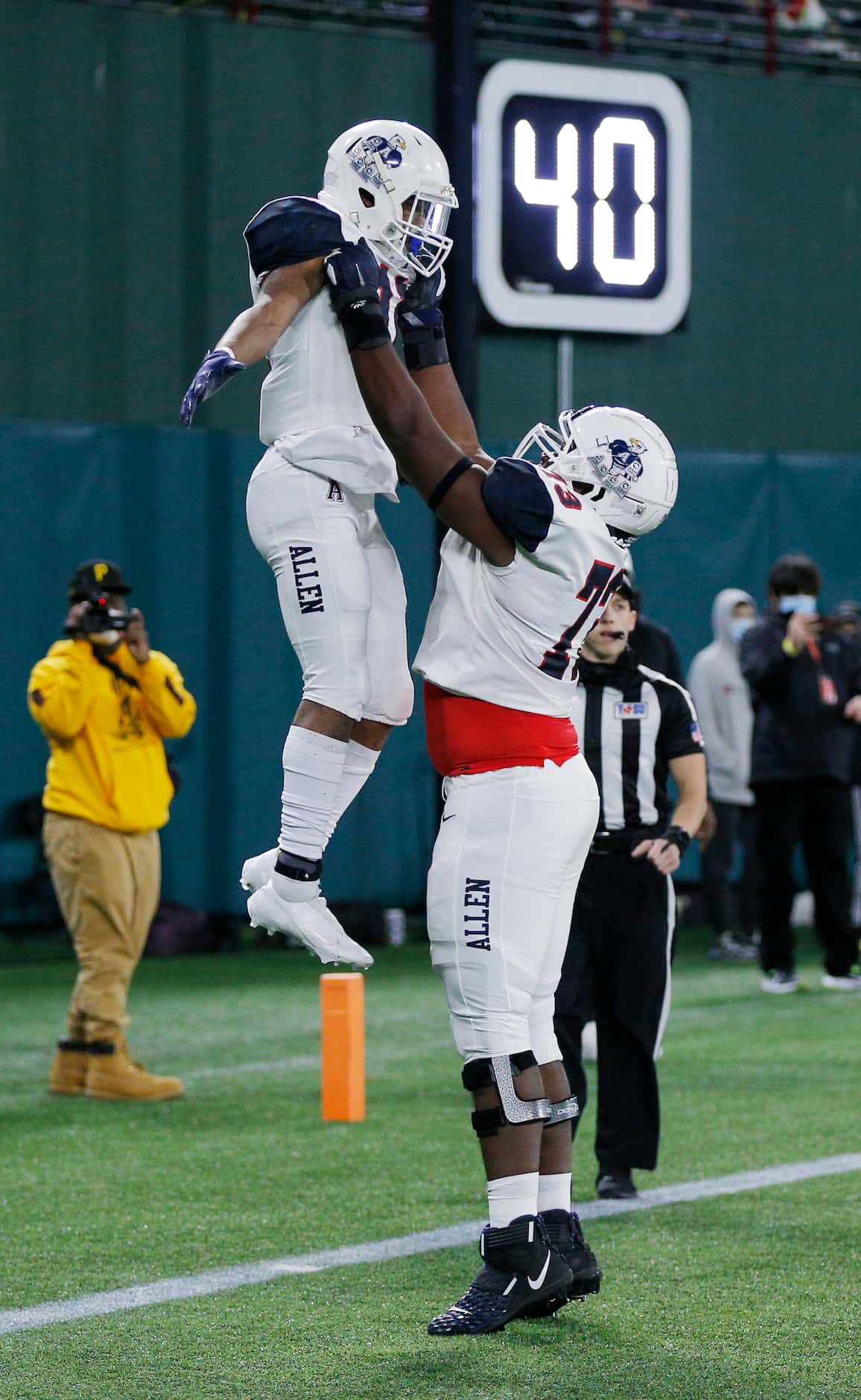Allen senior vide receiver Jordan Johnson (11) is lifted into the air after scoring a...
