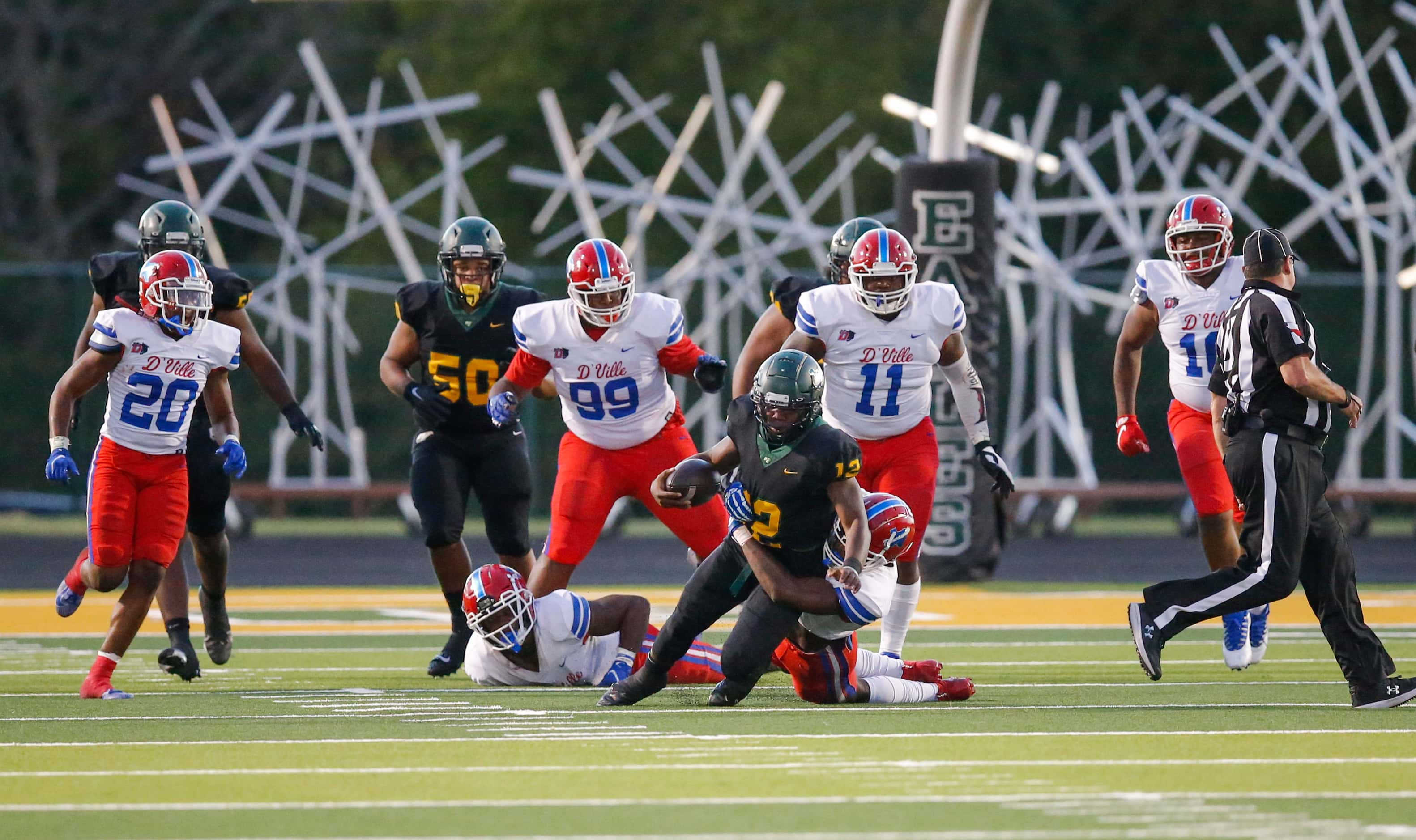DeSoto senior quarterback Matt Allen (12) is tackled by Duncanville senior linebacker Jordan...