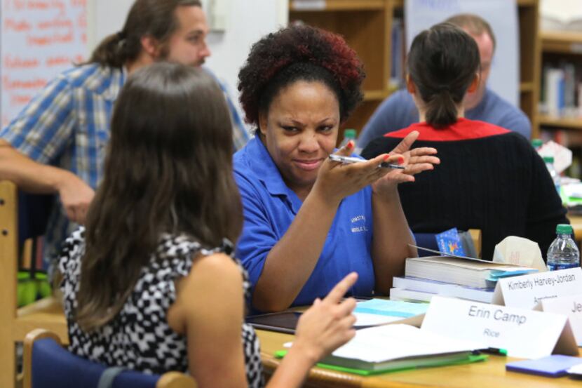Armstrong Middle School English teacher Kimberly Harvey-Jordan (center) talked with Rice...