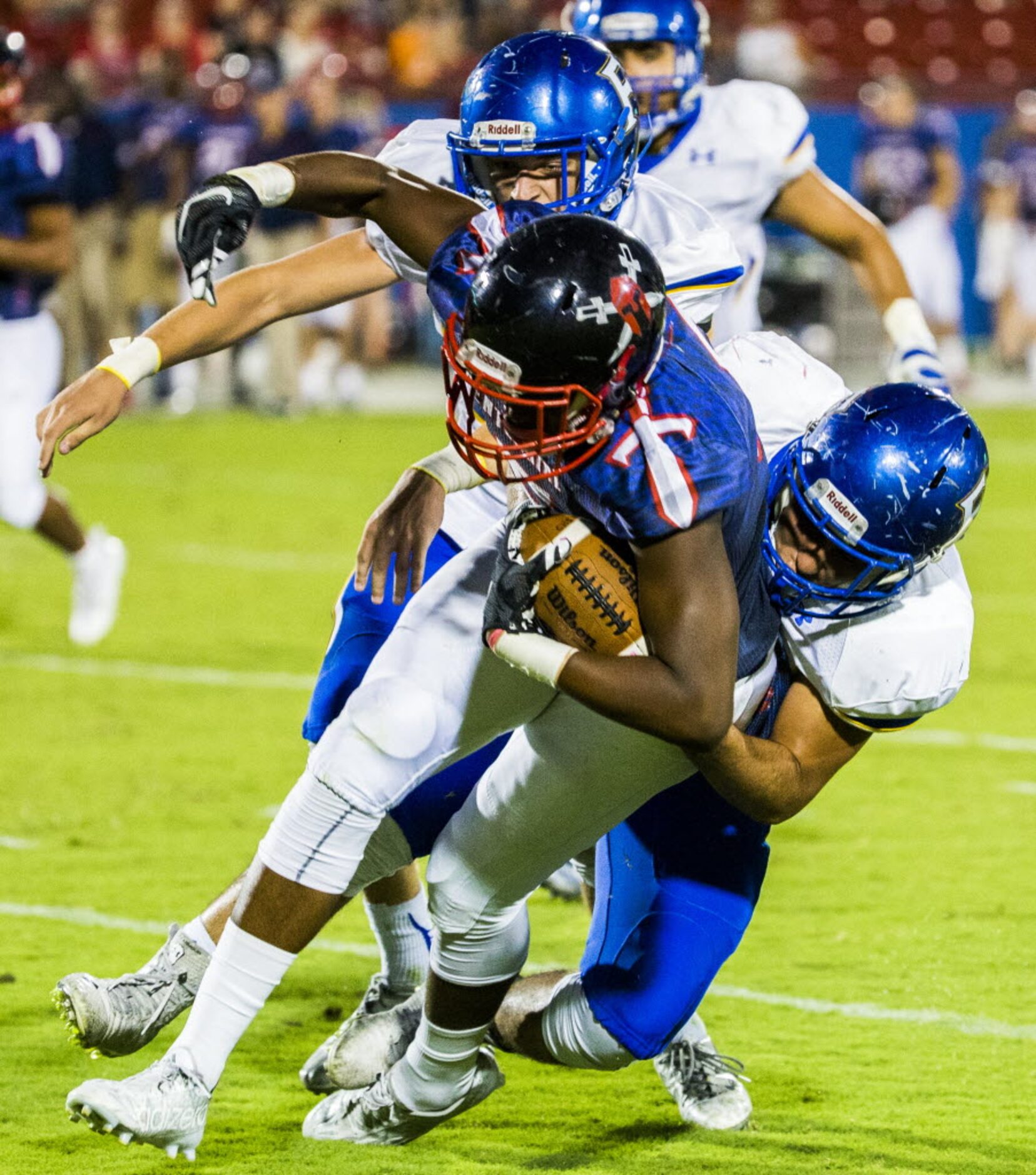 Frisco Centennial wide receiver Kenny Nelson (5) is tackled by Frisco defensive back Ethan...