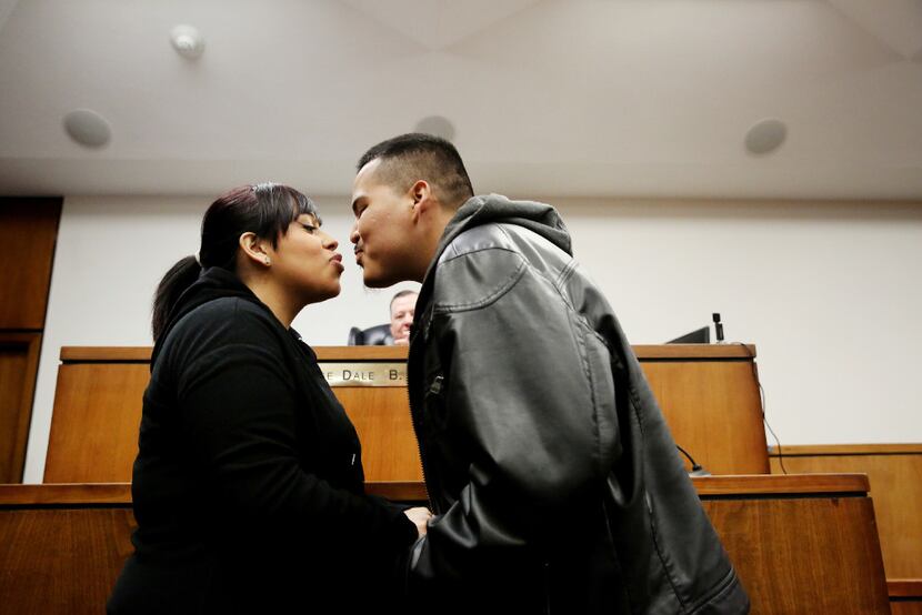 Lizette Torres (left) kisses Gonzalo Ramirez, both of Dallas, after they are married in the...