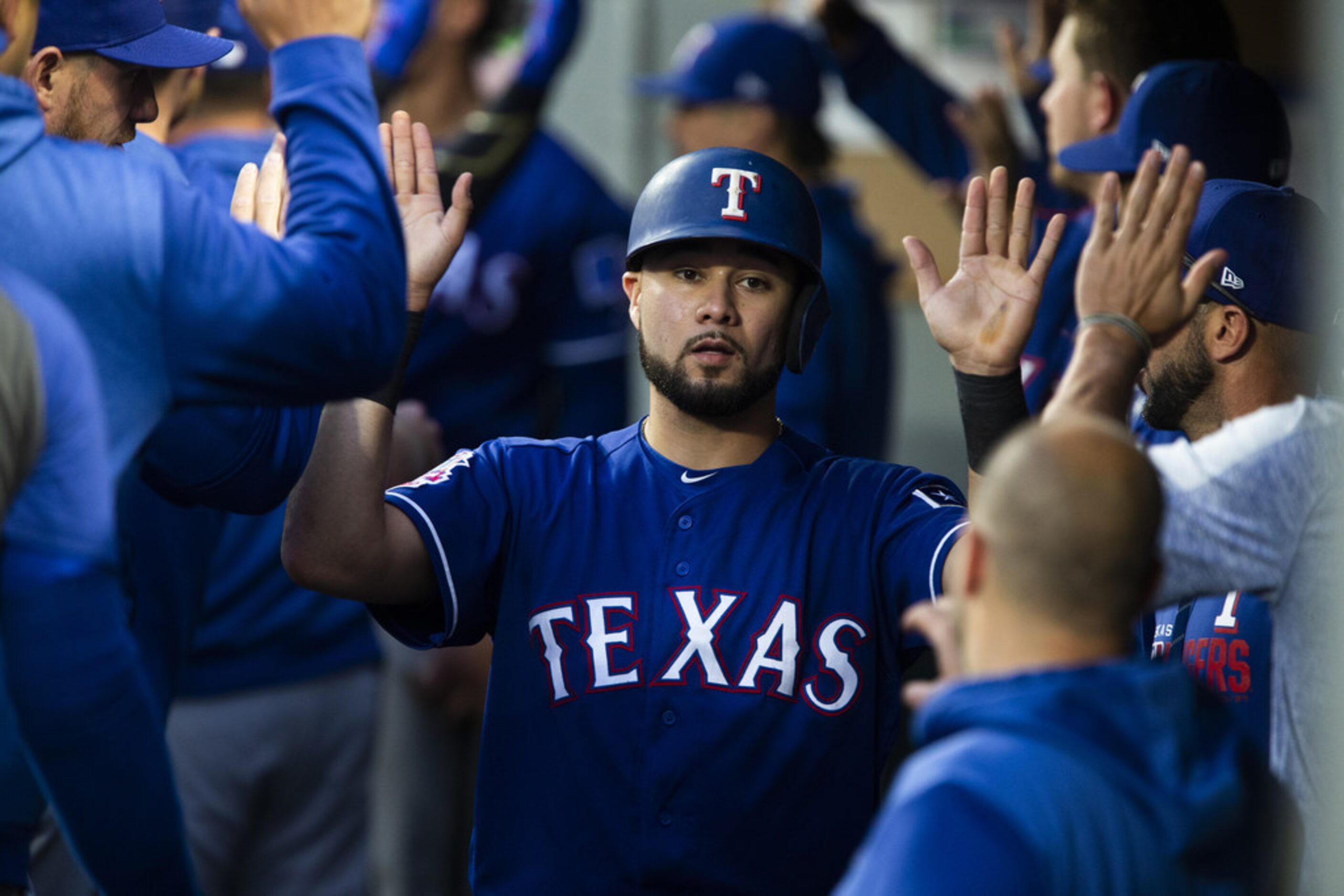 SEATTLE, WA - MAY 28:  Isiah Kiner-Falefa #9 of the Texas Rangers is greeted in the dugout...