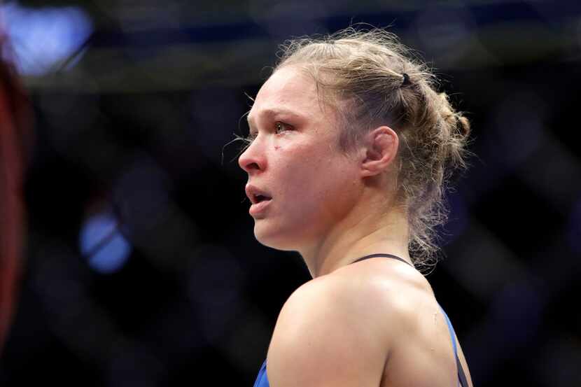 FILE - In this Dec. 30, 2016, file photo, Ronda Rousey stands in the cage after Amanda Nunes...