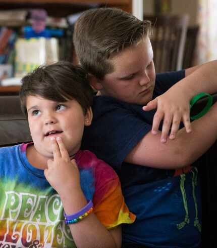 Marilyn Morrison, 9, makes a face alongside her playful brother Miles, 10.
