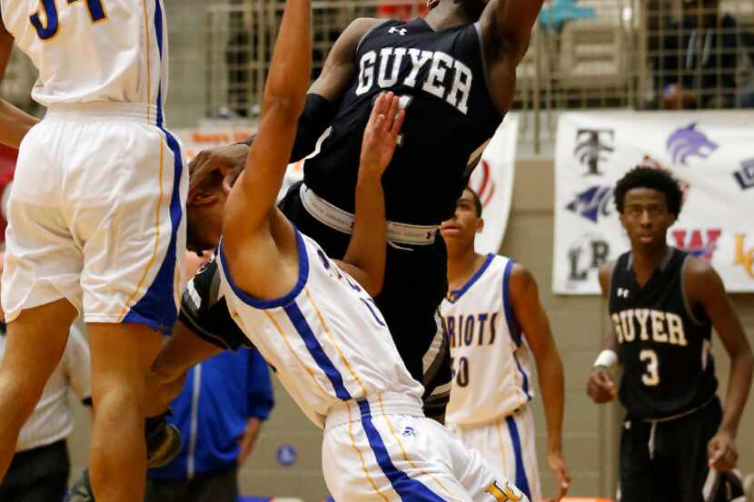 Denton Guyer's Devion Harmon (11) is fouled by Lakeview Centennial's Nicolas Rene (21) on...