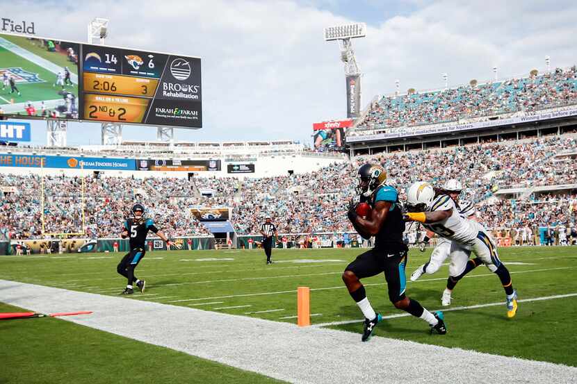Jacksonville Jaguars wide receiver Marqise Lee (11) scores a touchdown while being defended...