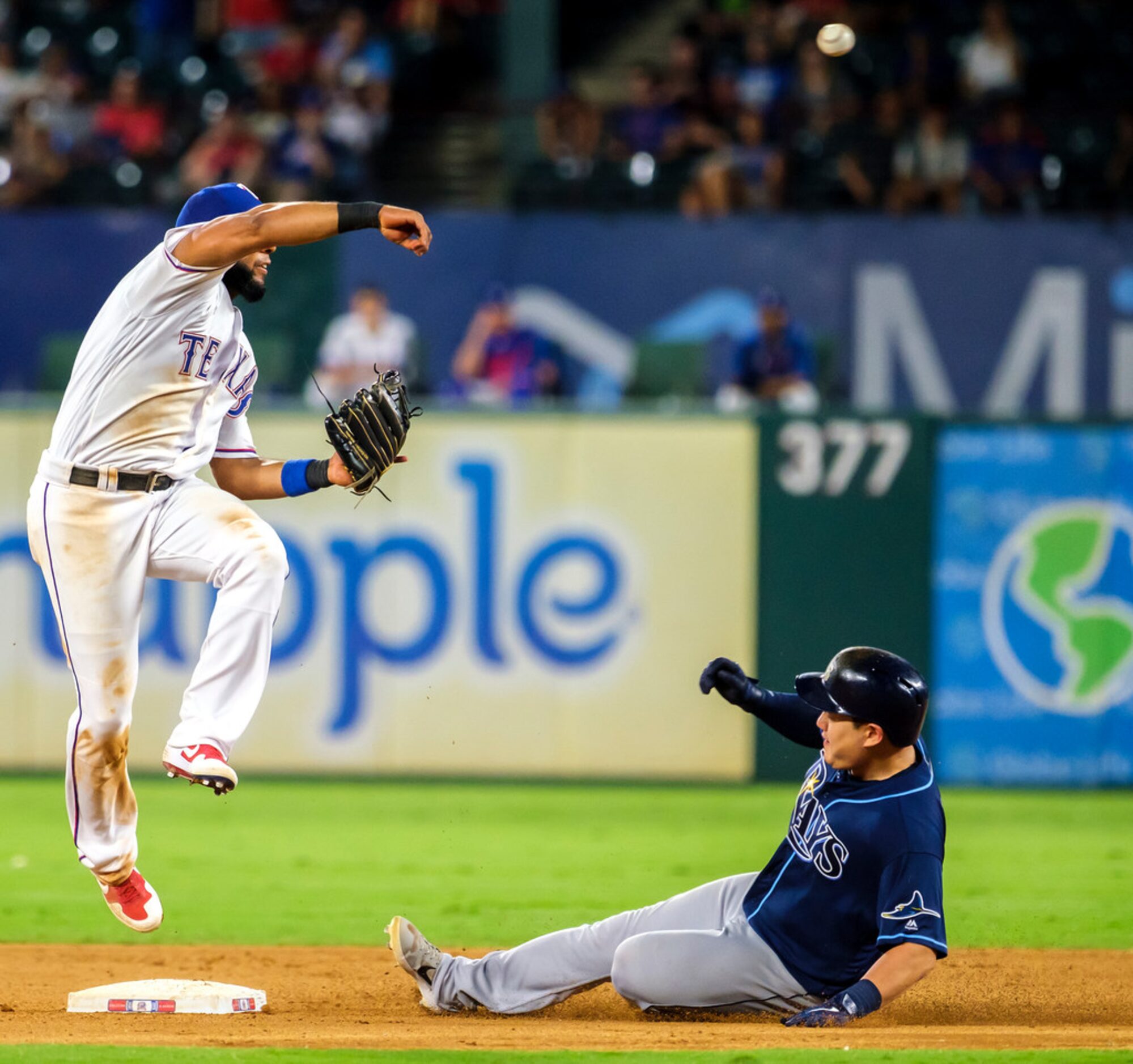 Texas Rangers shortstop Elvis Andrus (1) tries to turn a double play over Tampa Bay Rays...