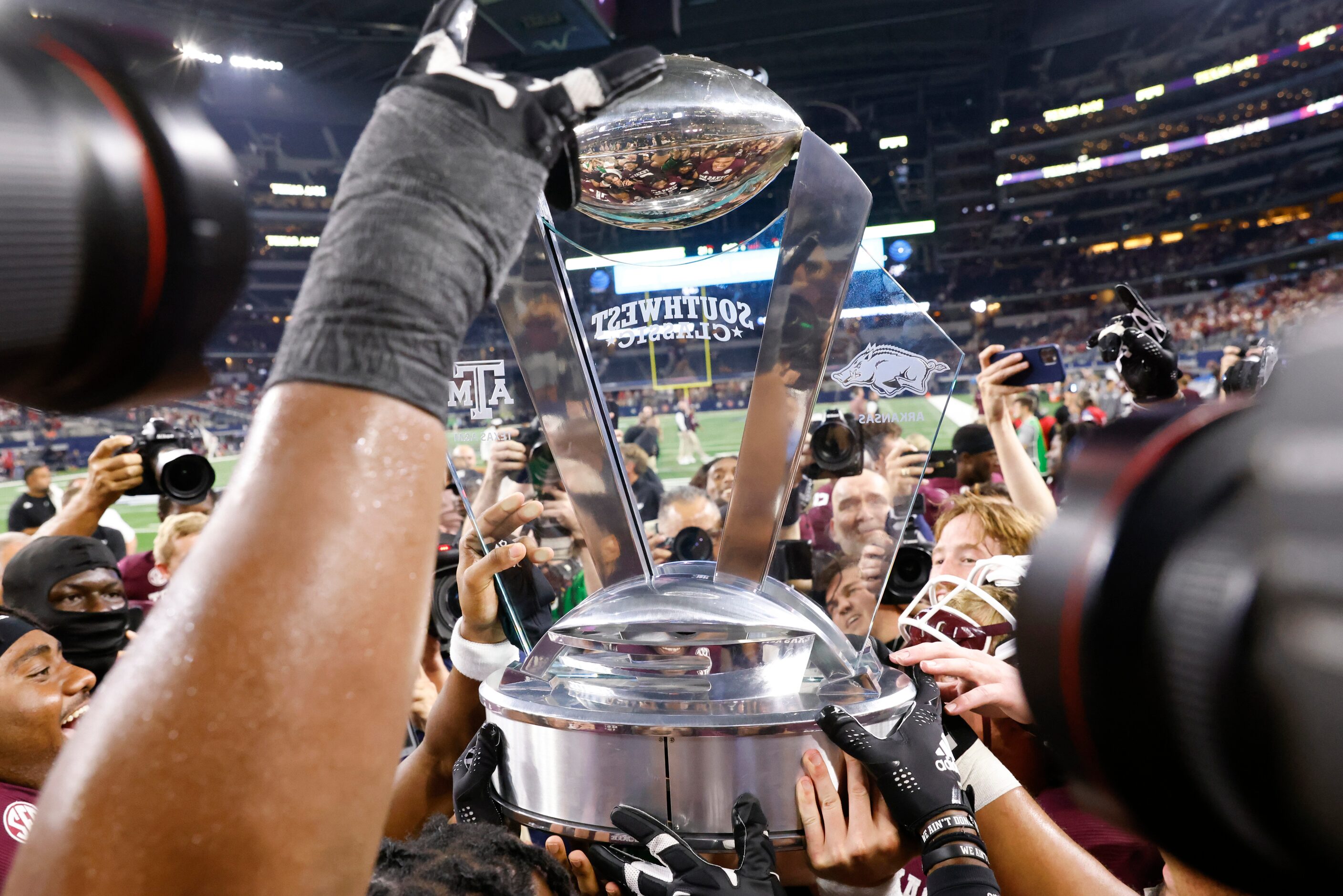 Texas A&M players celebrate after winning against Arkansas at AT&T Stadium in Arlington on...