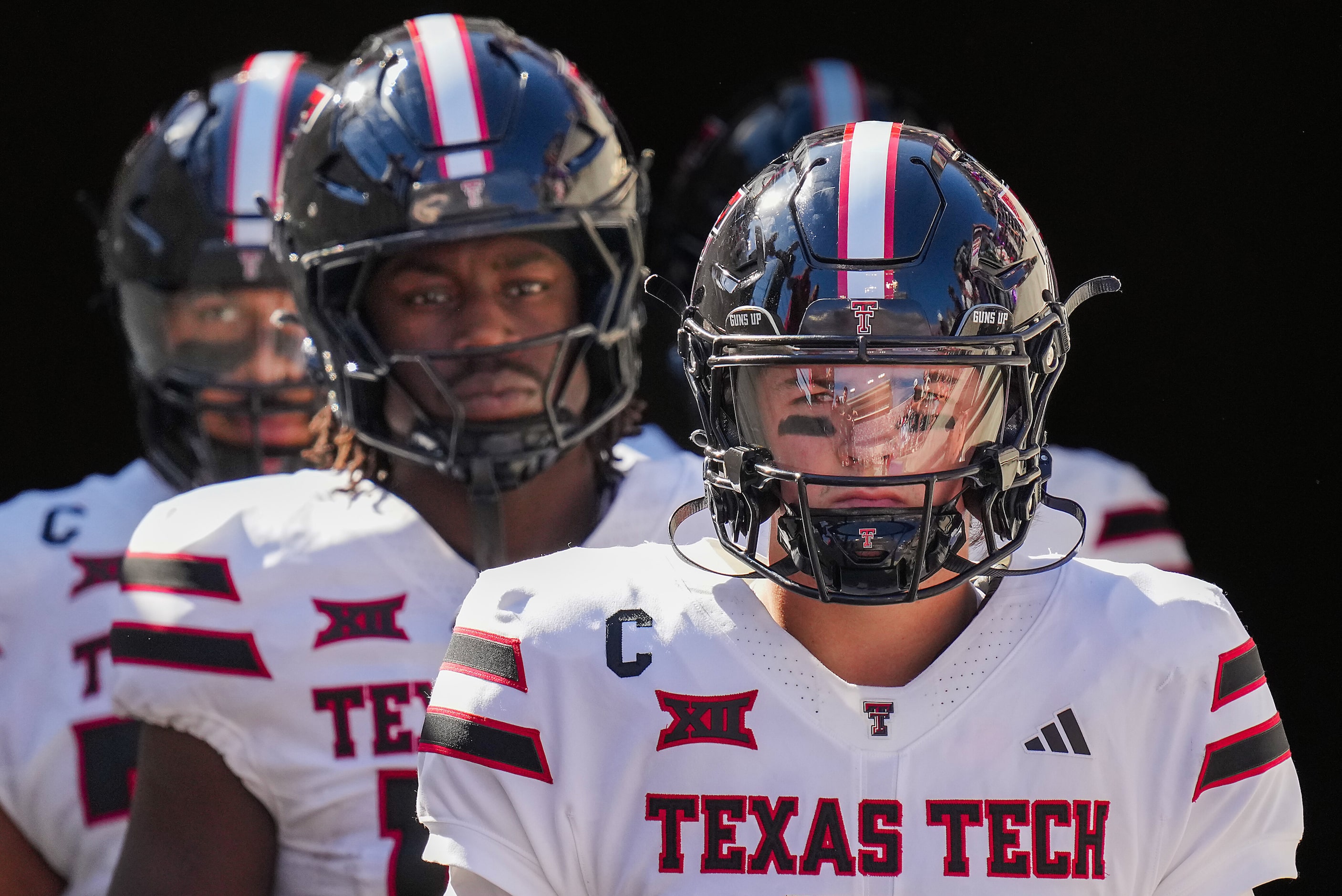 Texas Tech quarterback Behren Morton leads teammates as they take the field before an NCAA...