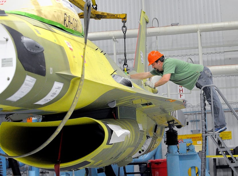 The last F-16, RA-28, was lifted by an overhead crane and moved to a paint station at...
