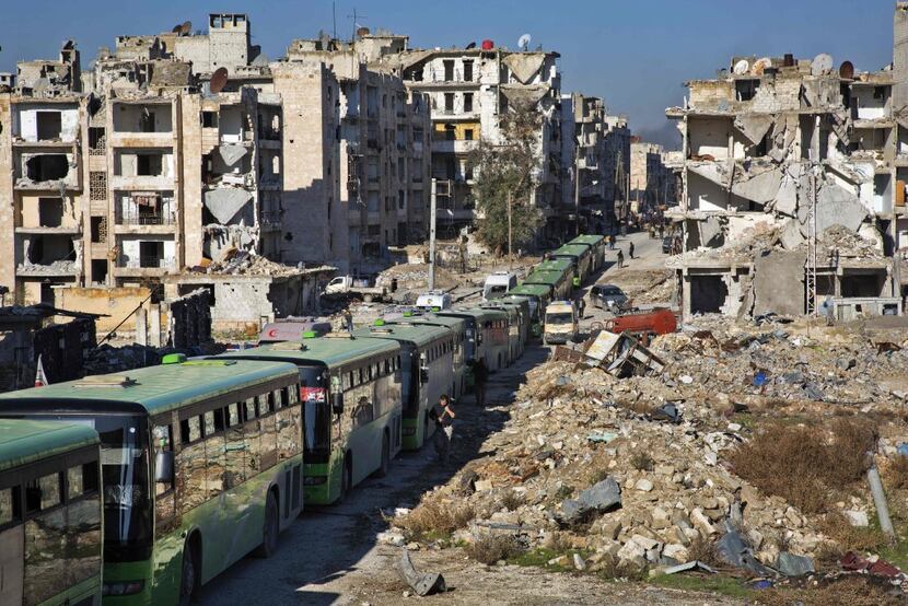 Buses line up during an evacuation operation of rebel fighters and their families from...