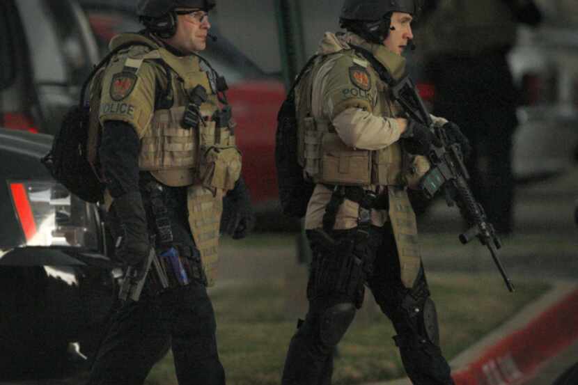 Grand Prairie police SWAT members entered the office building off State Highway 360 at North...