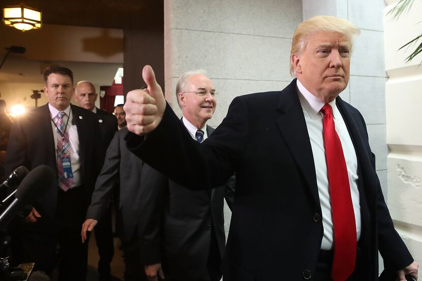 U.S. President Donald Trump gives a thumbs up as he and HHS Secretary Tom Price walk to a...