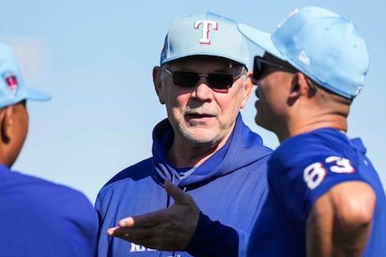 Texas Rangers manager Bruce Bochy talks with associate manager Will Venable (83) during a...