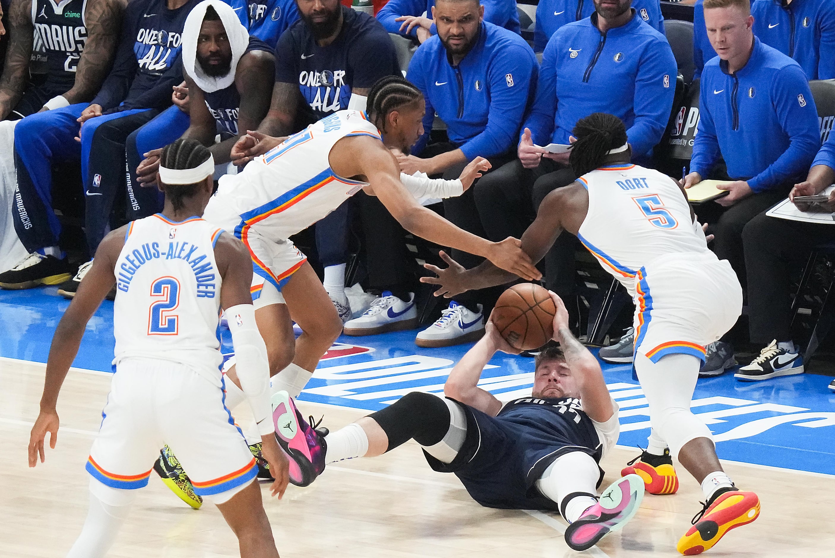 Dallas Mavericks guard Luka Doncic (77) struggles for a loose ball against Oklahoma City...