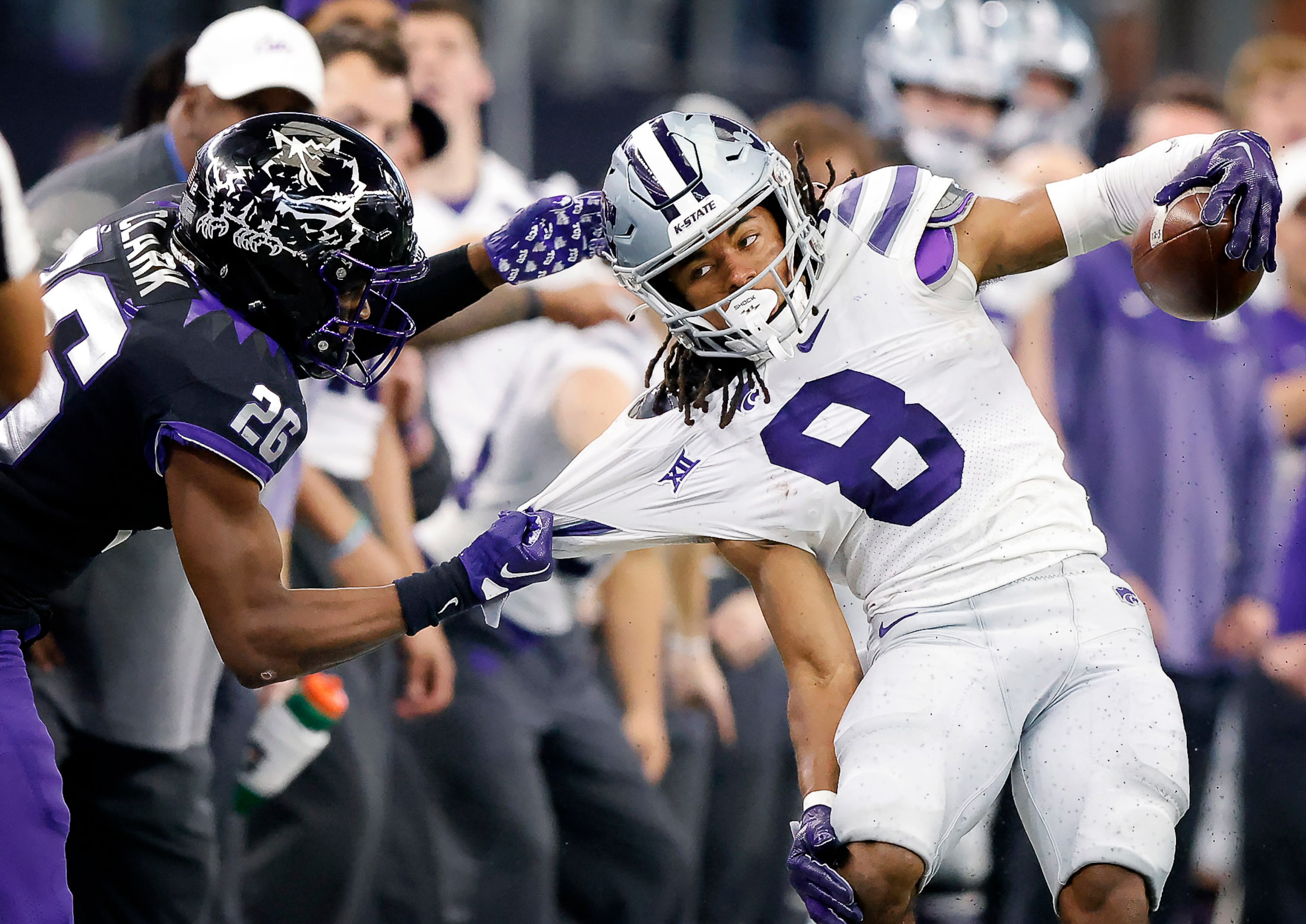 Kansas State Wildcats wide receiver Phillip Brooks (8) is pulled out of bounds by TCU Horned...