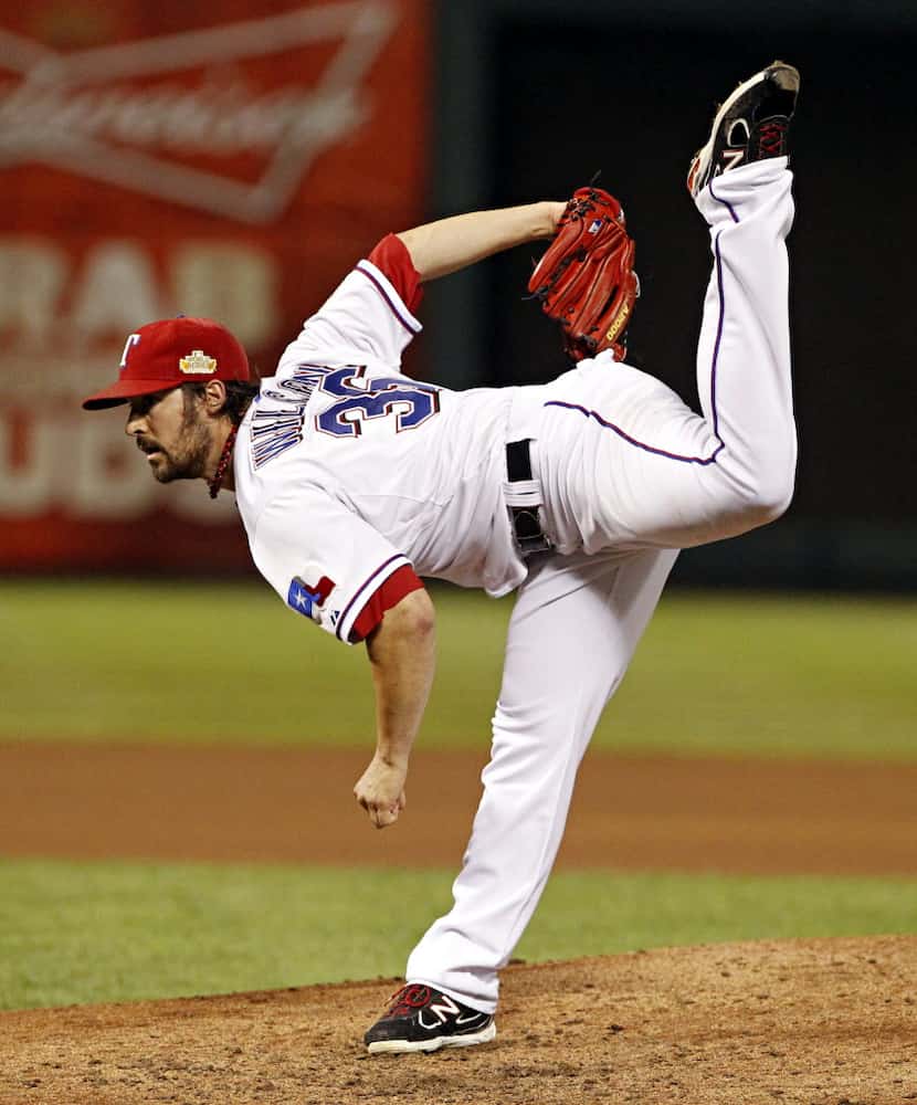 FILE - Texas Rangers starting pitcher C.J. Wilson pitches in the fifth inning during Game 5...