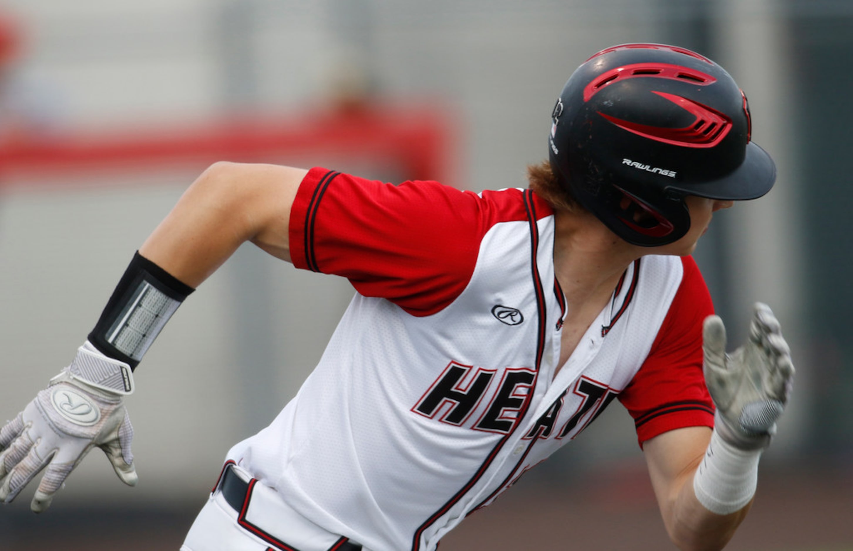 Rockwall Heath outfielder Miller Ladusau (12) bolts out of the batter's box and reaches base...