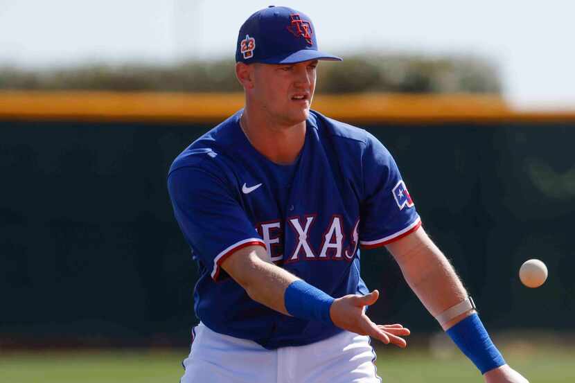 Texas Rangers infielder Josh Jung goes through a drill during a spring training workout at...