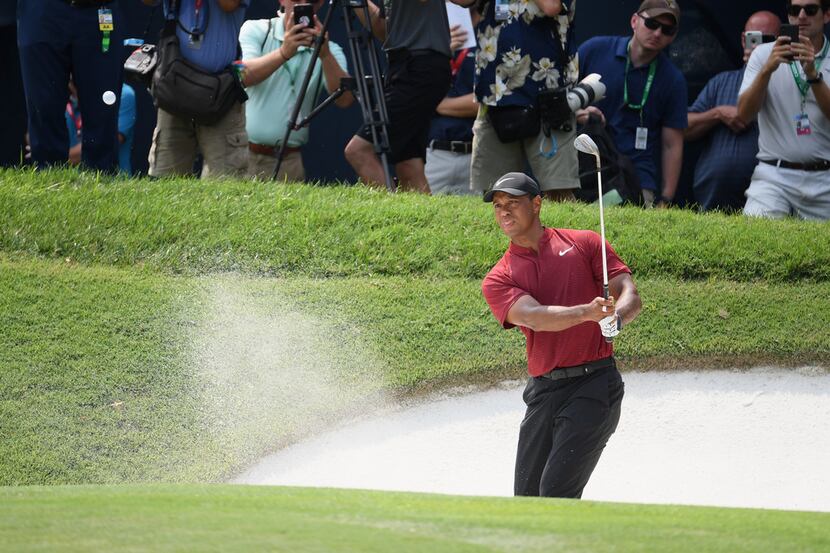 ST LOUIS, MO - AUGUST 12:  Tiger Woods of the United States plays a shot from a bunker on...