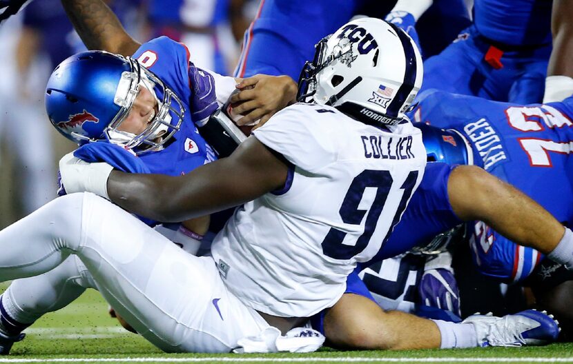 Southern Methodist Mustangs quarterback Ben Hicks (8) is sacked by TCU Horned Frogs...