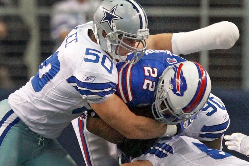 Dallas LB Sean Lee (50), with his hand heavily bandaged, helps make the stop on Fred Jackson...