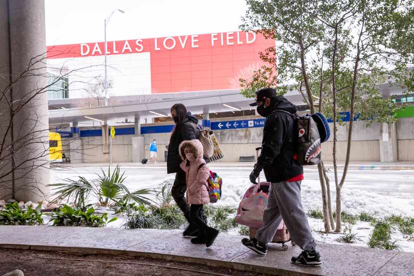 Yoli Cardona (from left), Sammi Jo Cardona, 6, and Sammy Cardona arrive at Dallas Love Field...
