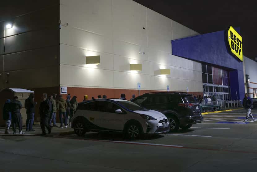 People wait in line for Best Buy to open Friday, Nov. 25, 2022 in Dallas. Best Buy...