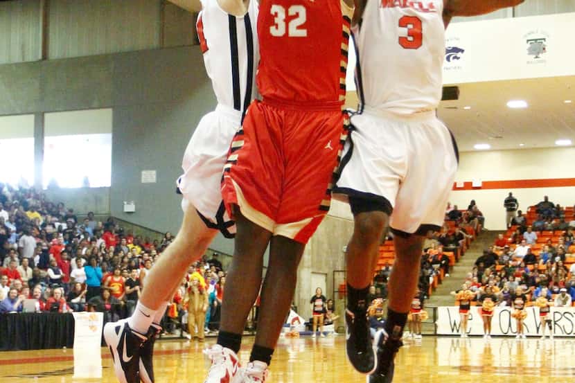 Chris Washburn (32) is double-teamed by Jared Hamilton and Marcus Smart of Flower Mound...