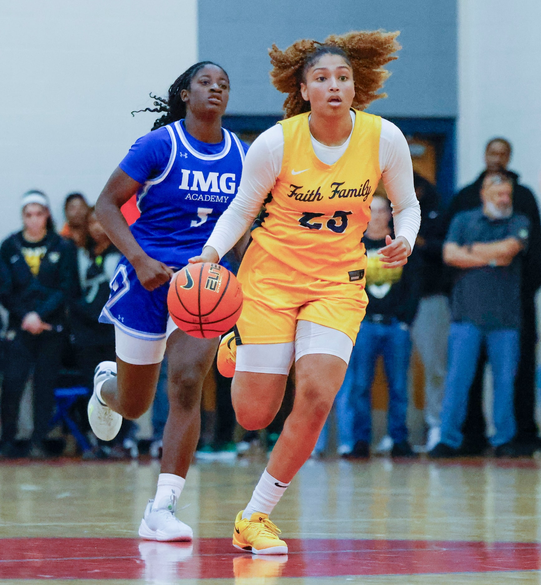 Oak Cliff Faith Family Academy’s Amayah Garcia (front) dribbles the ball against IMG Academy...