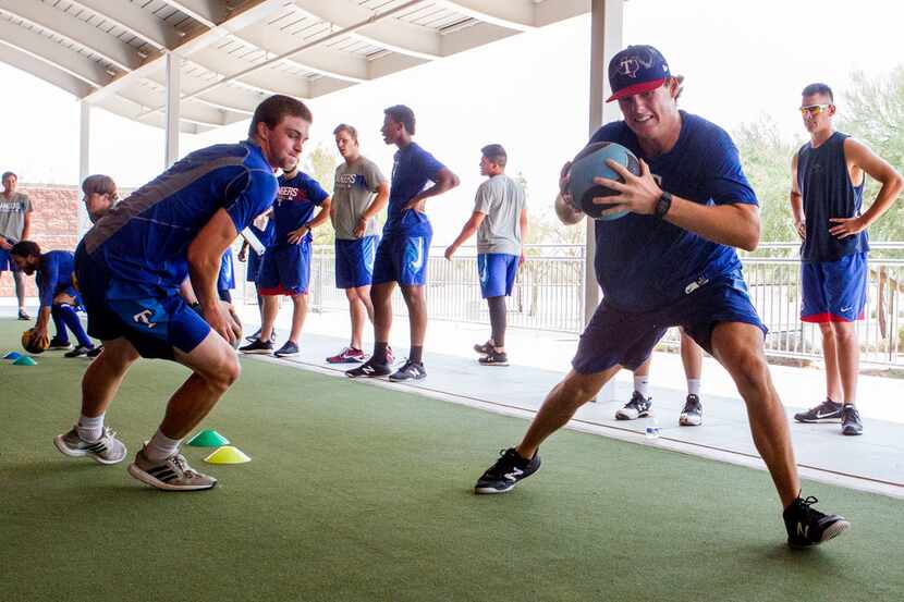 Texas Rangers' pitcher Mason Englert (right) does a drill against Wyatt Sparks(left) that...