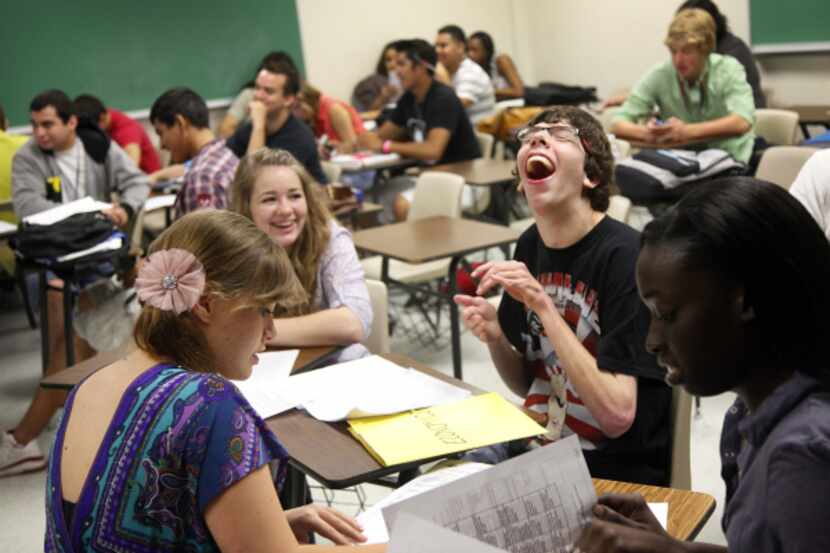 Trinity High School senior Trae Caster (second from right) laughed at a teacher's joke as he...