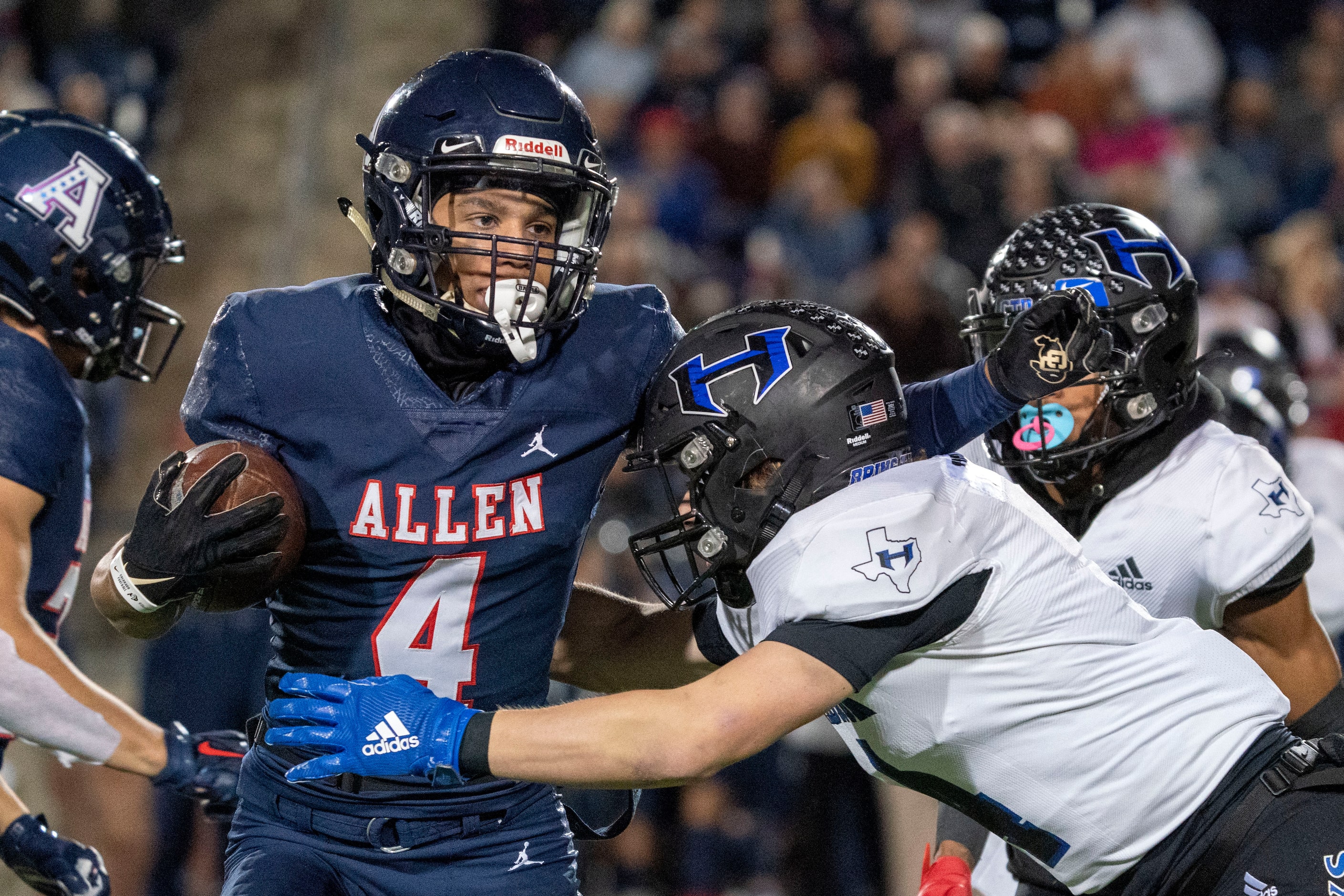 Allen senior wide receiver Jordyn Tyson (4) tries to break the tackle of Hebron safety...