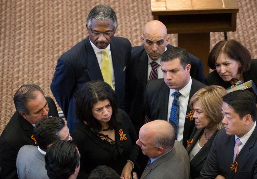 Democrats huddle on the House floor to discuss a deal to end the debate or continue the...