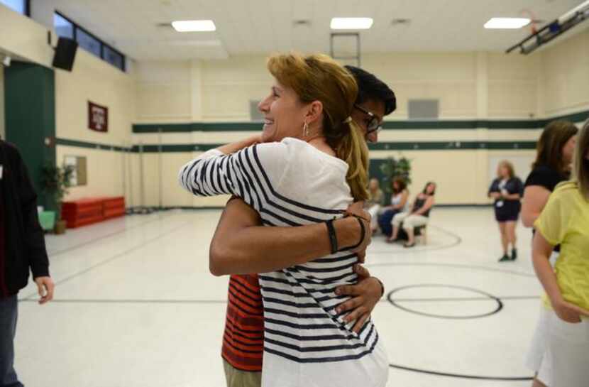 
Fifth grade teacher Jennifer Novak-Martellotto hugs former student and graduating senior...