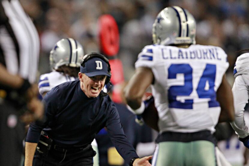Dallas Cowboys head coach Jason Garrett (left) congratulates cornerback Morris Claiborne...