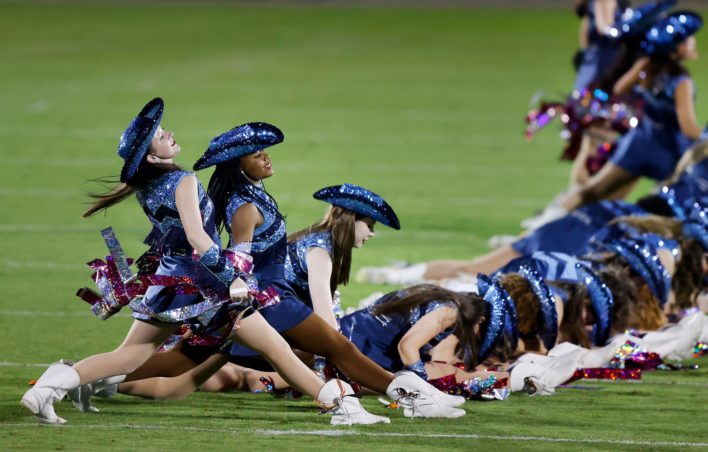 Frisco Emerson Majestics Varsity Drill Team members slide into the splits during their...