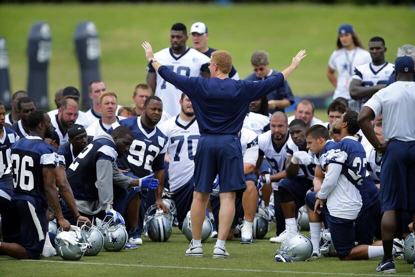 Dallas Cowboys head coach Jason Garrett huddles up his players at the end of OTA practice at...