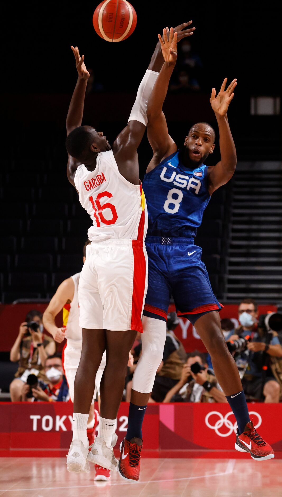 USA’s Khris Middleton (8) passes the ball forward in front of Spain’s Unman Garuba (16)...