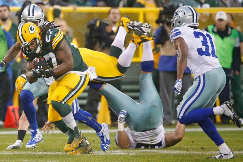 Green Bay Packers running back Eddie Lacy (27) powers his way to extra yardage on a run in...