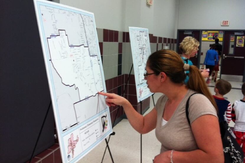 Erica Nava views maps of the elementary school attendance boundaries being proposed by the...