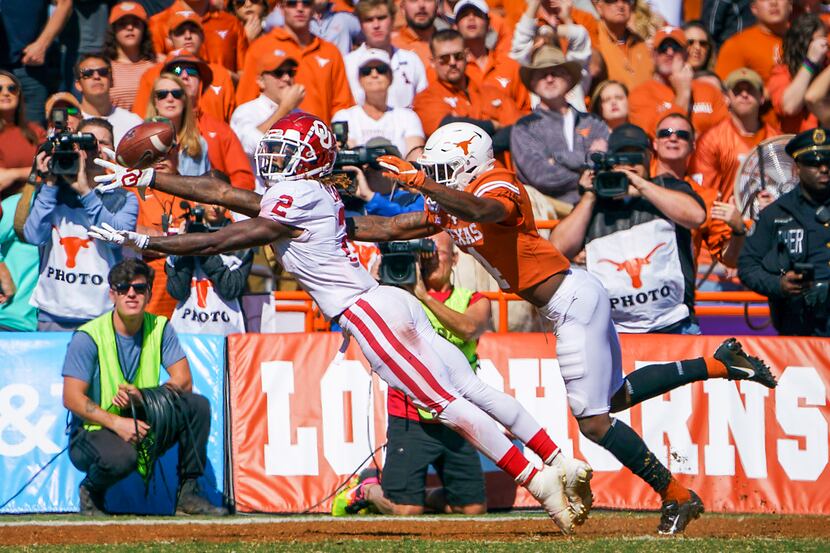 FILE - Oklahoma wide receiver CeeDee Lamb (2) attempts to make a catch while Texas defensive...