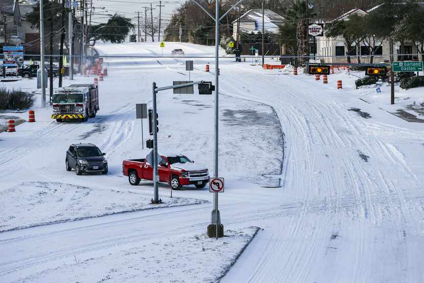 Garland Road near White Rock Lake covered in snow on Monday morning as a winter storm brings...