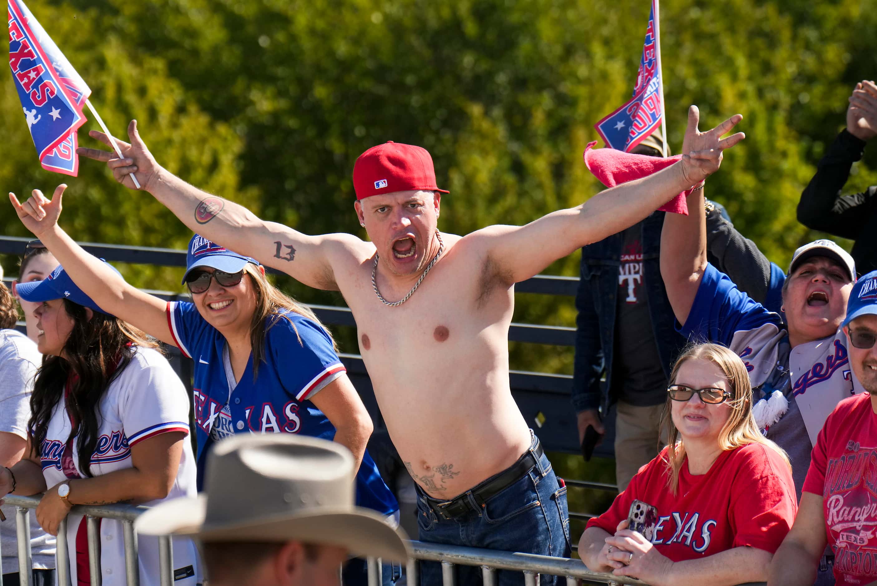 Fans cheer along the parade route during the Texas Rangers World Series victory parade,...