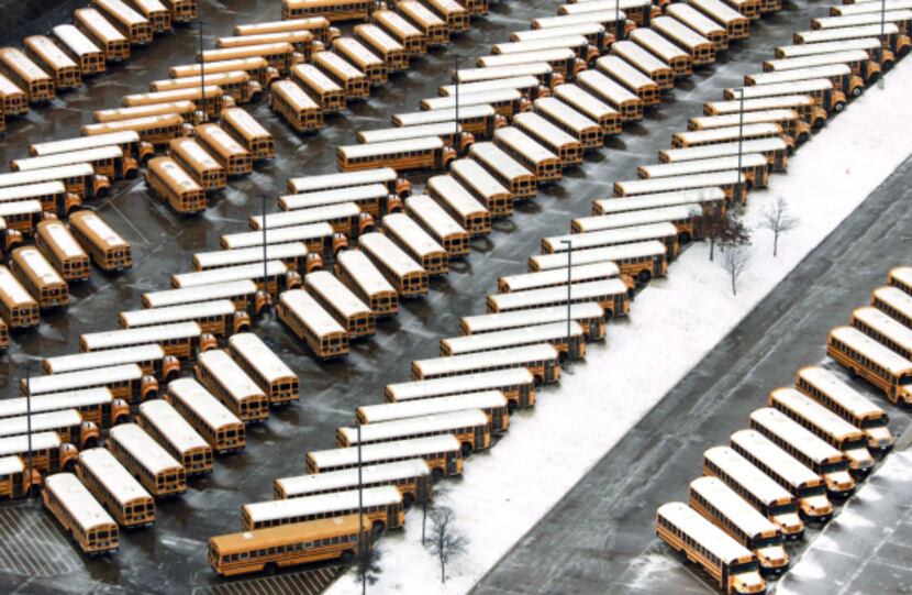 Stacks and stacks of school buses were parked and going nowhere off Interstate 35E.