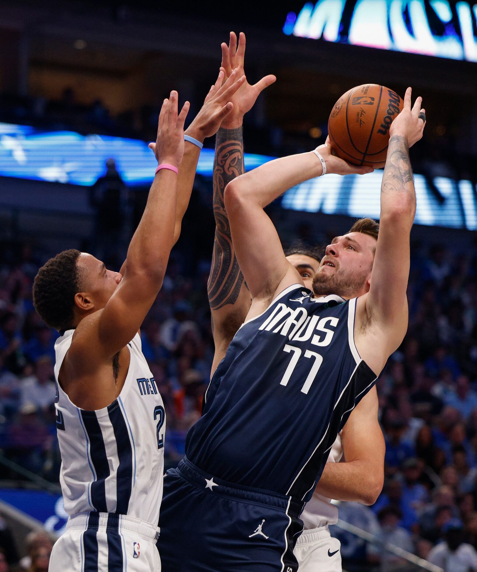 Dallas Mavericks guard Luka Doncic (77) puts up a shot over Memphis Grizzlies guard Desmond...