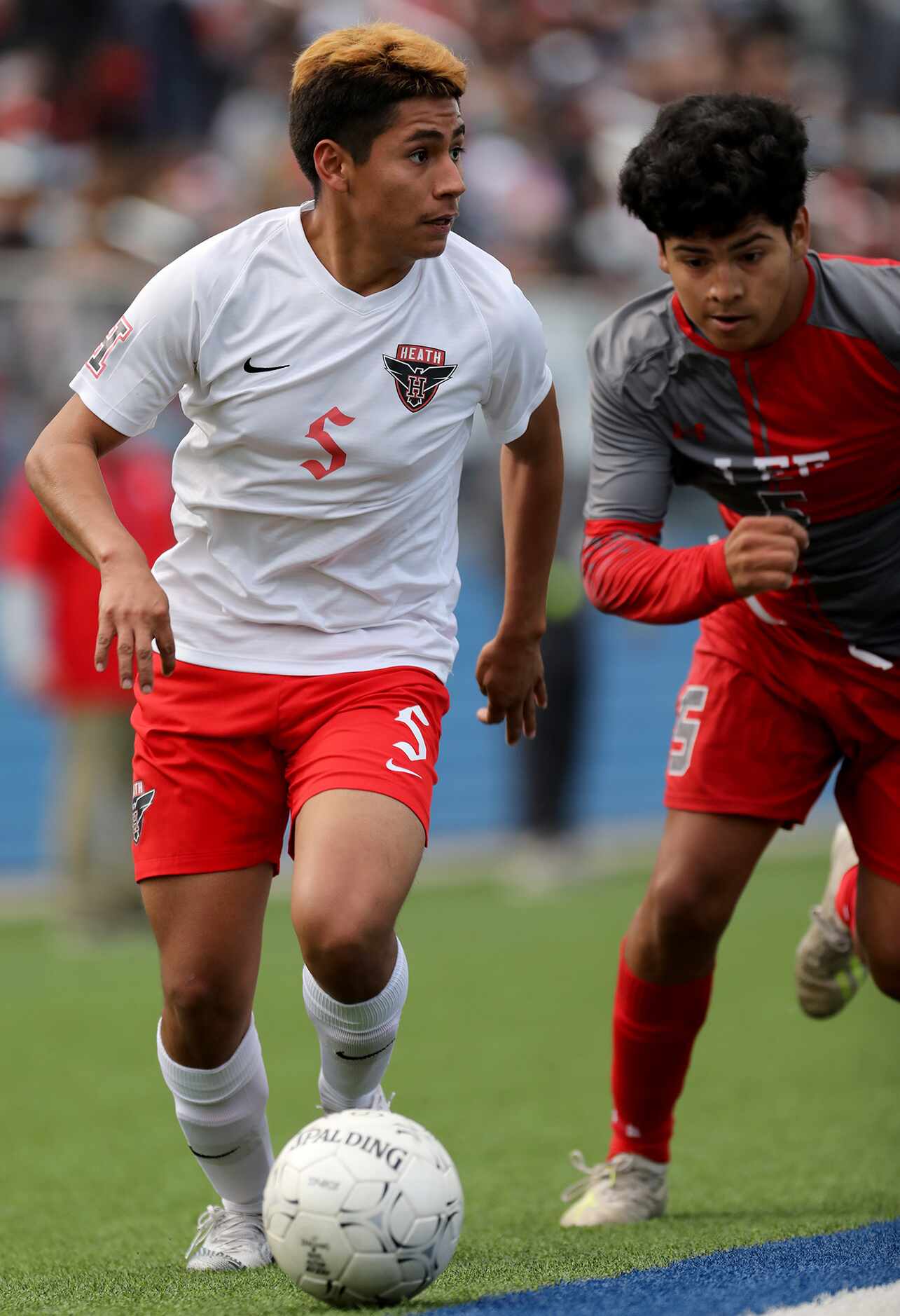 Rockwall-Heath's Chris Rodriguez (5) and SA Lee's Giovani Garcia (5) chase after the ball...